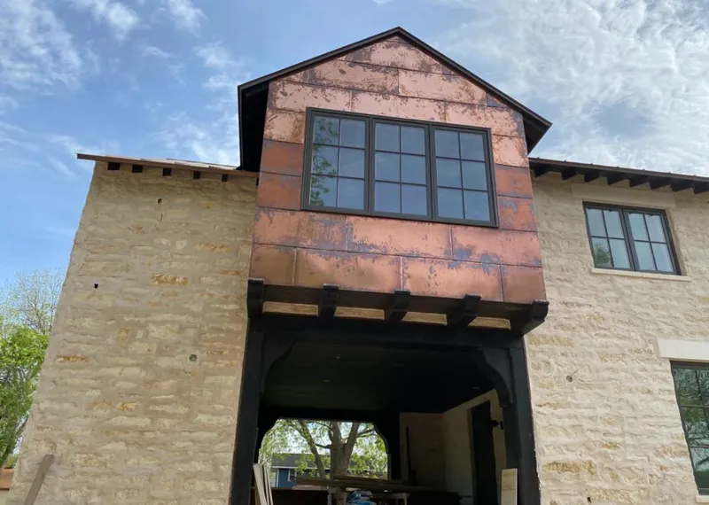 Copper metal panel facade on a stone building for Metal Roof Coating in Tupelo