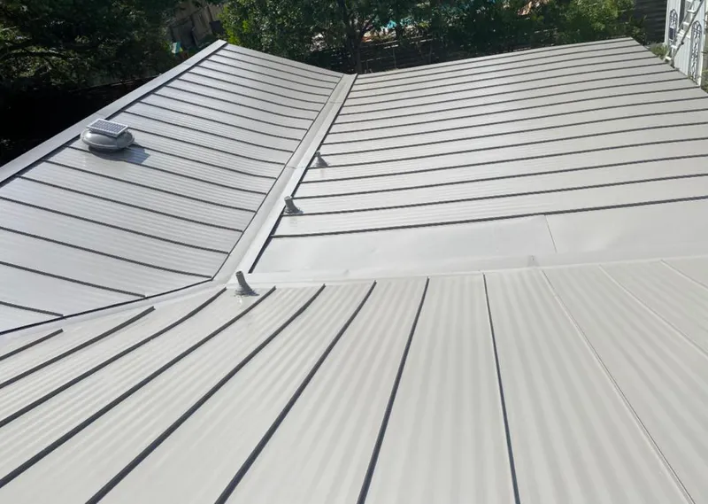 Solar attic fan installed on a metal roof for Roof Ventilation in Tupelo